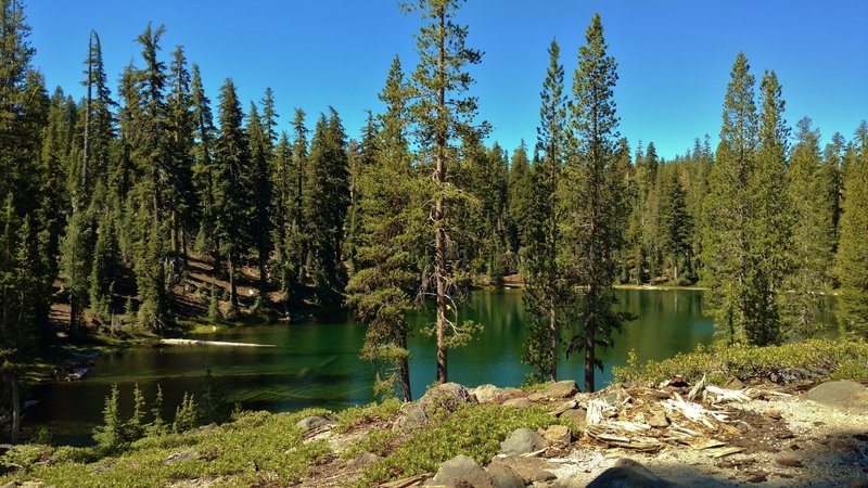 The blue-green waters of a small unnamed lake along Bear Lakes Trail.