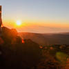 The sun peaks above the clouds over the Indian Ocean as seen from the summit of Piton des Neiges