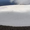 Hikers crossing the crater snowfield