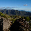 Piton des Neiges towers over the ravine carved by Riviere de l'Est. Parts of the heavily eroded shield of Piton des Neiges that surround Cirque de Salazie tower to the right.