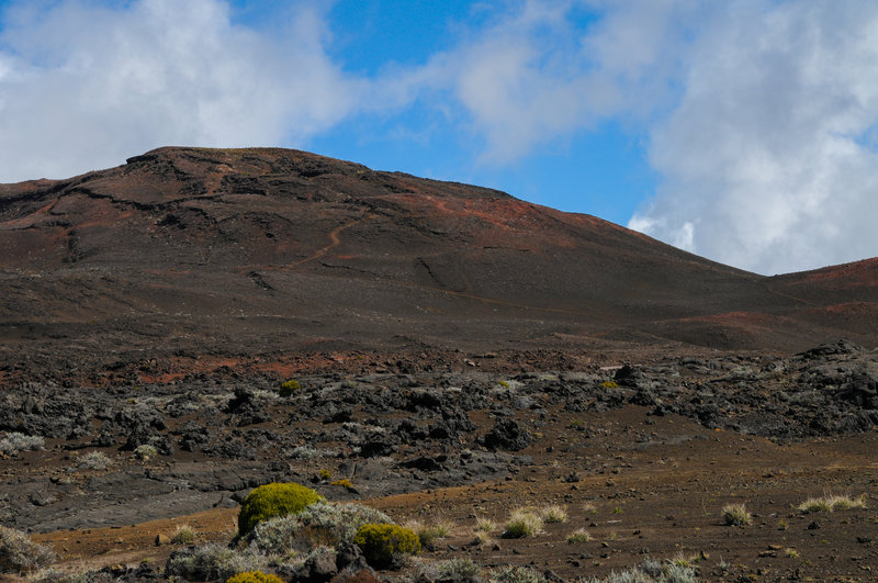 Piton Chisny's reds and browns look great against the blue sky in this martian landscape