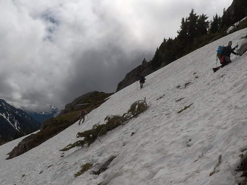 Climbing up a snow bank to the trail.