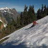 One hiker sliding down a snowbank.