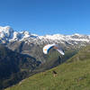 A common paraglider launch from the grassy hillside