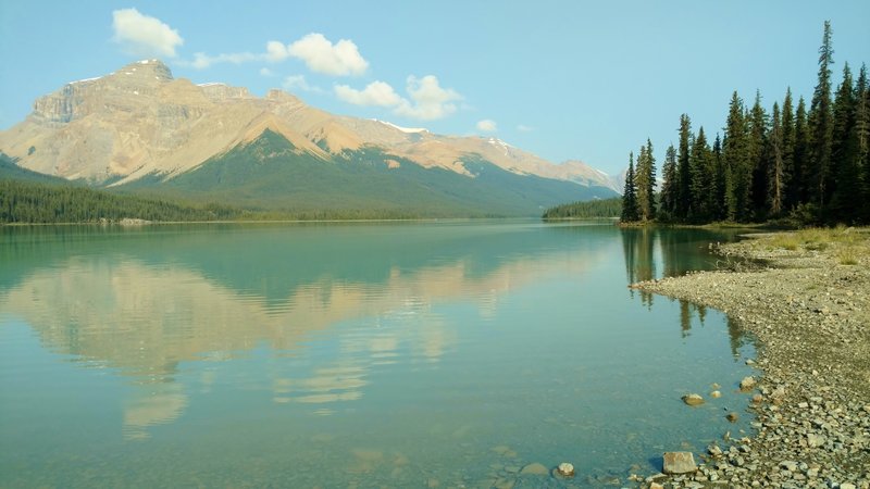 Brazeau Lake, a large backcountry lake, in the early morning, looking west-northwest along the shore at the Brazeau Lake Trail Camp.