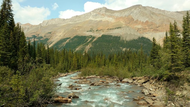 John-John Creek cascades downstream close to where it empties into Brazeau Lake, as seen looking northeast from Pobotkan Pass Trail at the John-John Creek crossing.