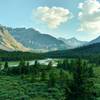 The Brazeau River meanders through the meadows in the shadows, as the mountains catch the last rays of the setting evening sun