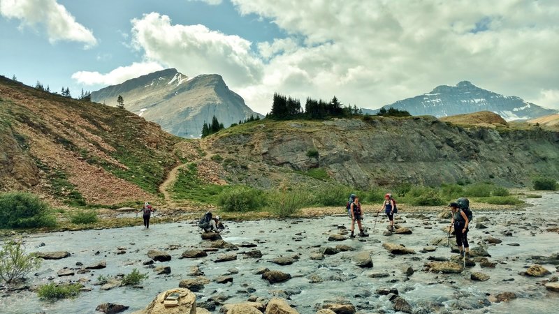 Now what? - Crossing the Brazeau River just below Nigel Pass. Two on the left take off their boots, three on the right rock hop it.