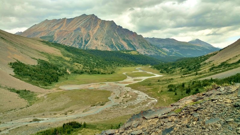 The Brazeau River runs through meadows at the base of the north side of Nigel Pass. This awesome view surprises upon rounding a bend in the trail when descending the pass.