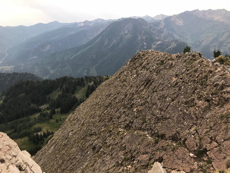 A cool rock slab off the side of Mount Raymond with Mount Kessler in the background and the south side of Big Cottonwood Canyon