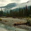 The Blaeberry River spreads out over gravel flats in a flat area along the David Thompson Heritage Trail