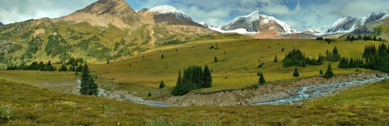 Calumet Creek headwaters flow through the expansive Moose Pass meadows below rugged Peaks of Calumet Ridge. Looking northwest from just west of Moose Pass.