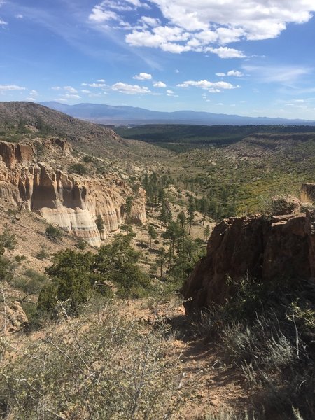 Cliffs with Sangre De Cristo Mountains in the distance.