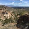 Cliffs with Sangre De Cristo Mountains in the distance.