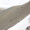 The trail might have snow lingering in shaded areas, even in late June. You can see the trail as it leads out to Scenic Point off in the distance.