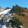 Summit ridge on right and hiker's summit in center.