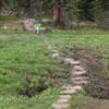 Crossing bog in upper meadow before you begin the final ascent to lake.