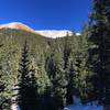 Steeper section of trail covered in snow on a nice afternoon.