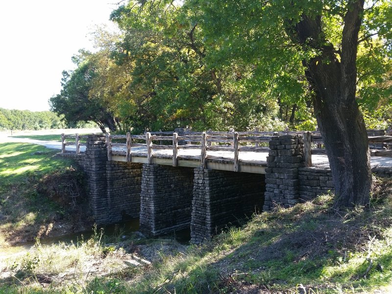 Iconic CCC bridge featured in park souvenirs such as path tags and shirts.
