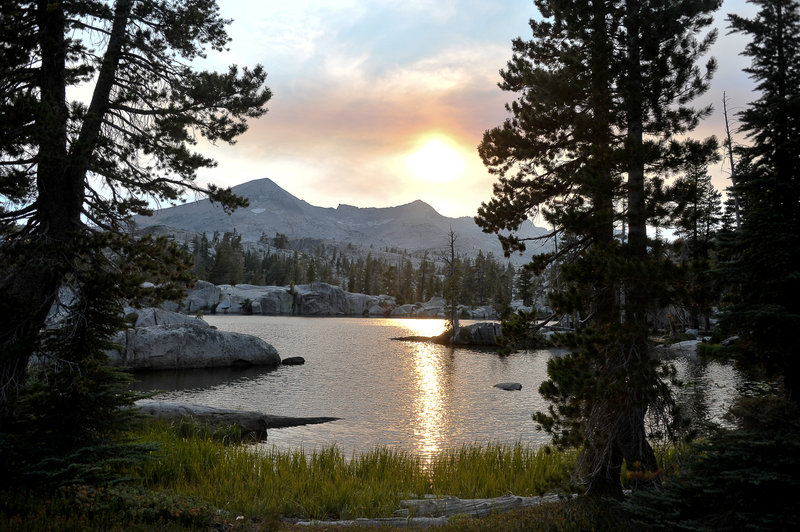 Lake of the Woods with the sun setting through wild fire smoke in the distance