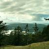 The San Juan Islands and Canada are seen through a break in the trees along Lost Oak Trail.