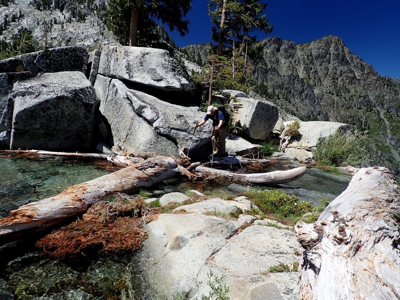 Crossing the outlet of Grizzly Lake, 20 feet from a 200-foot cliff