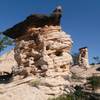 Hoodoos atop Panorama Point. The black caprock is hematite, formed deep inside the Navajo Sandstone when water dissolved the red iron oxide and concentrated it in a crack.