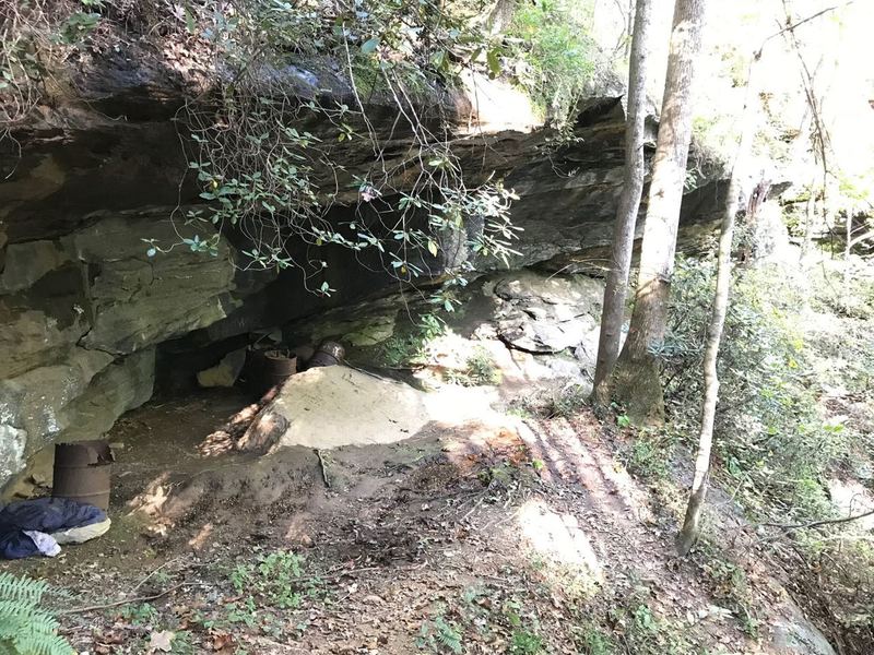 Moonshine Cave / overhang of Moonshine Falls with possible old moonshine barrels some say and is one of the few waterfalls you can walk behind staying dry. Little hard to see the actual falls on the right in this picture with the light hitting them.