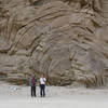 Two hikers at the anticline in the split of Split Mountain