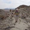 Hikers descending a spot elevation on the Split Mountain Loop