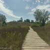 The Kohler Dunes Cordwalk as it stretches across grassy sand dunes.