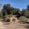 The entrance to the Moreno adobe from the trailhead. One of the many picnic tables can be seen in the background.