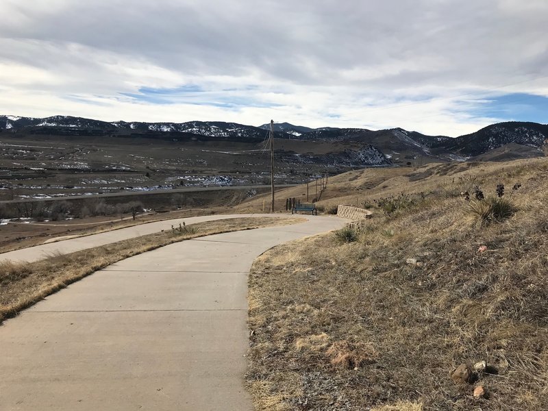 Descending switchback trail from reservoir crest.