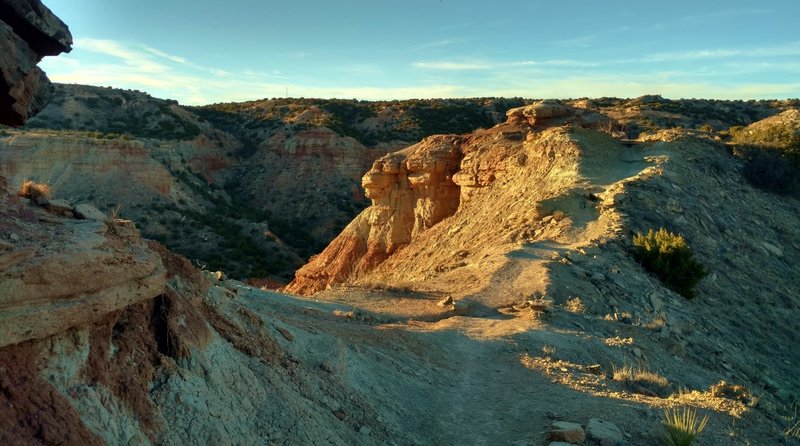 The CCC Trail runs along a narrow ridge that leads to Goodnight Peak, as the sun sets on a late afternoon in February.