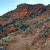 Red rock formations on the canyon walls can be seen from the CCC Trail as it drops down into the canyon.