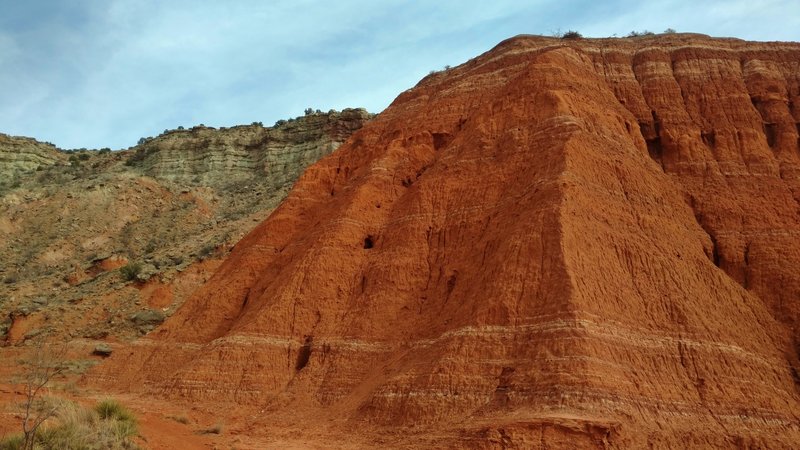 The various colors of the canyon wall layers up close, at the base of Fortress Cliffs on Comanche Trail North.