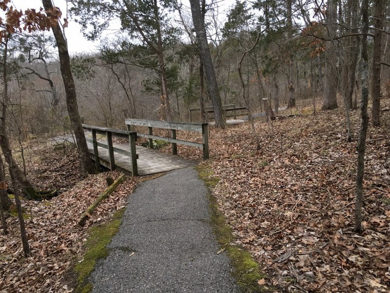 A couple wooden bridges that span gaps in the rocks.