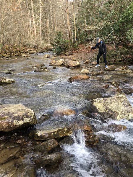 Pilgrim navigating one of many stream crossings.