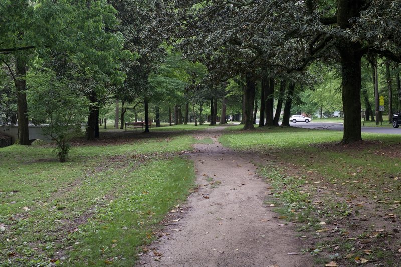 The dirt and gravel Whittington Trail runs underneath the shade of Magnolia and other native trees of Arkansas.