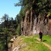 The trail traverses a steep drop just before the top of the falls