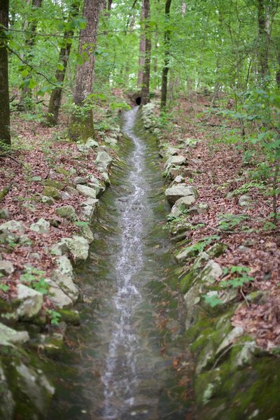 Water from recent rainstorms is diverted under the trail through troughs like this.