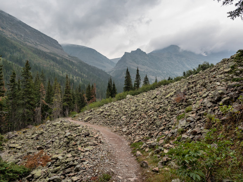 Passing through a rocky avalanche area on the ascent to Cracker Lake.