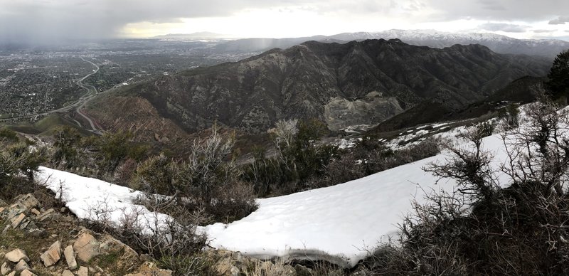 Looking down from the ridge into the quarry in Parley's Canyon. Grandview Mountain is in the far distance. Weather is inclement in the valley, drenching the GSL.