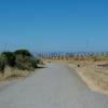 The trail departs the parking lot via a wide, gravel trail that leads out to the South San Francisco Bay.