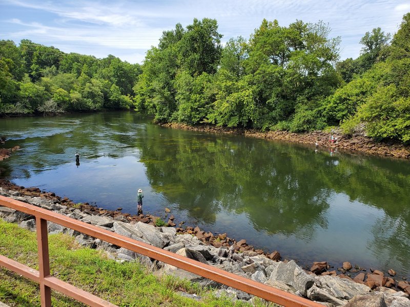 Chattahoochee River and people fly fishing. Buford Dam is on the right.