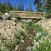 The trail goes over this bridge and follows this creek.