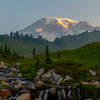 Looking up to Mount Rainier at sunrise from the bridge above Myrtle Falls.