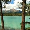 The turquoise waters of Lake Annette with Pyramid Mountain in the distance (center).