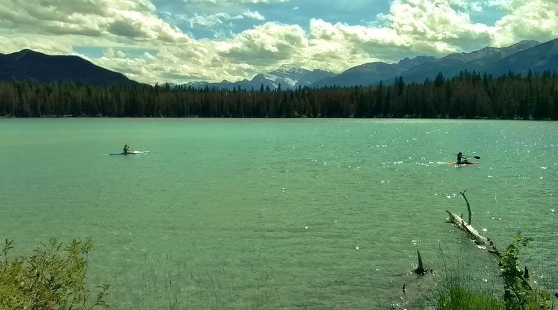 Kayakers enjoy Lake Annette.  Mount Edith Cavell is in the distance (center).