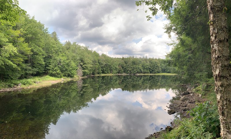 Beautiful calm lake at the very beginning of the hike.